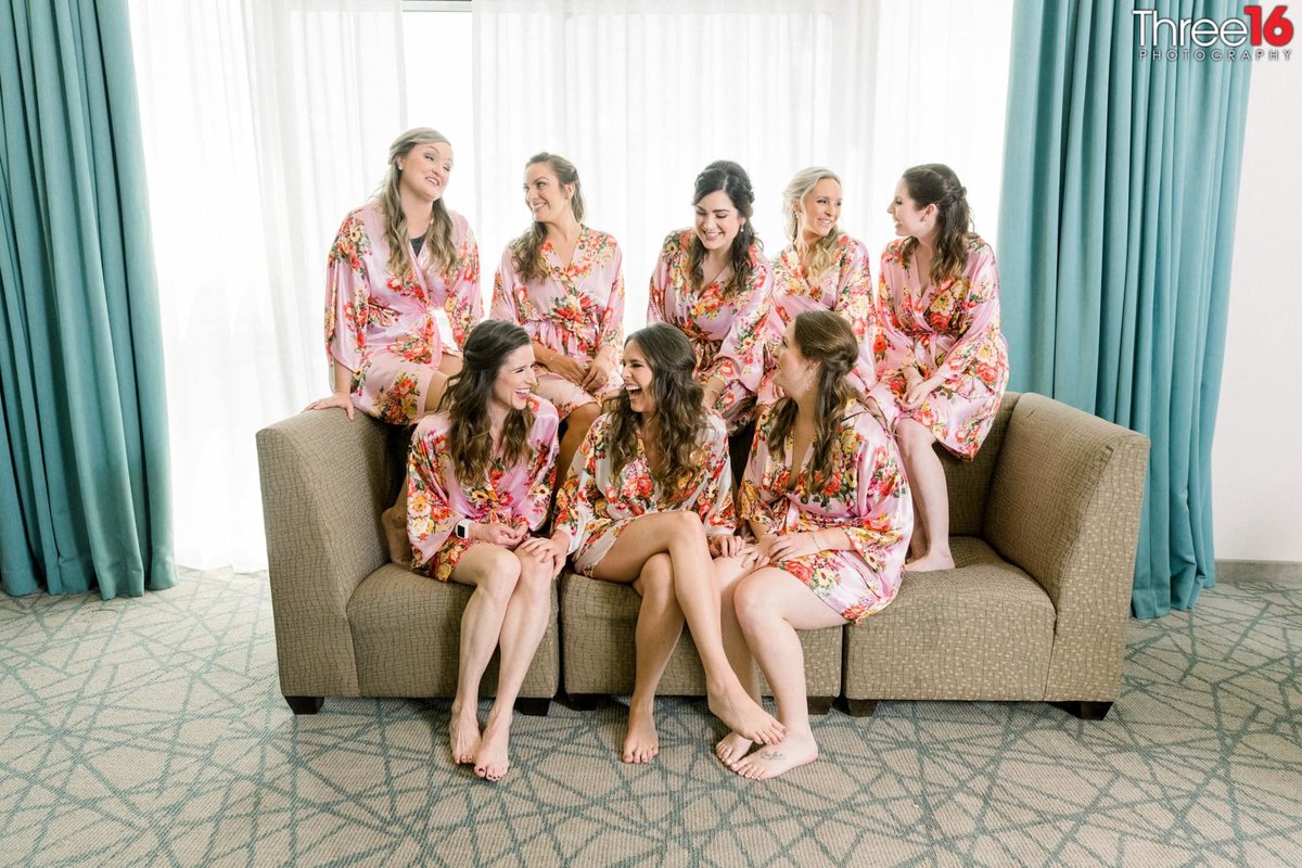 Bride and her Bridesmaids spend time together in their robes before getting dressed