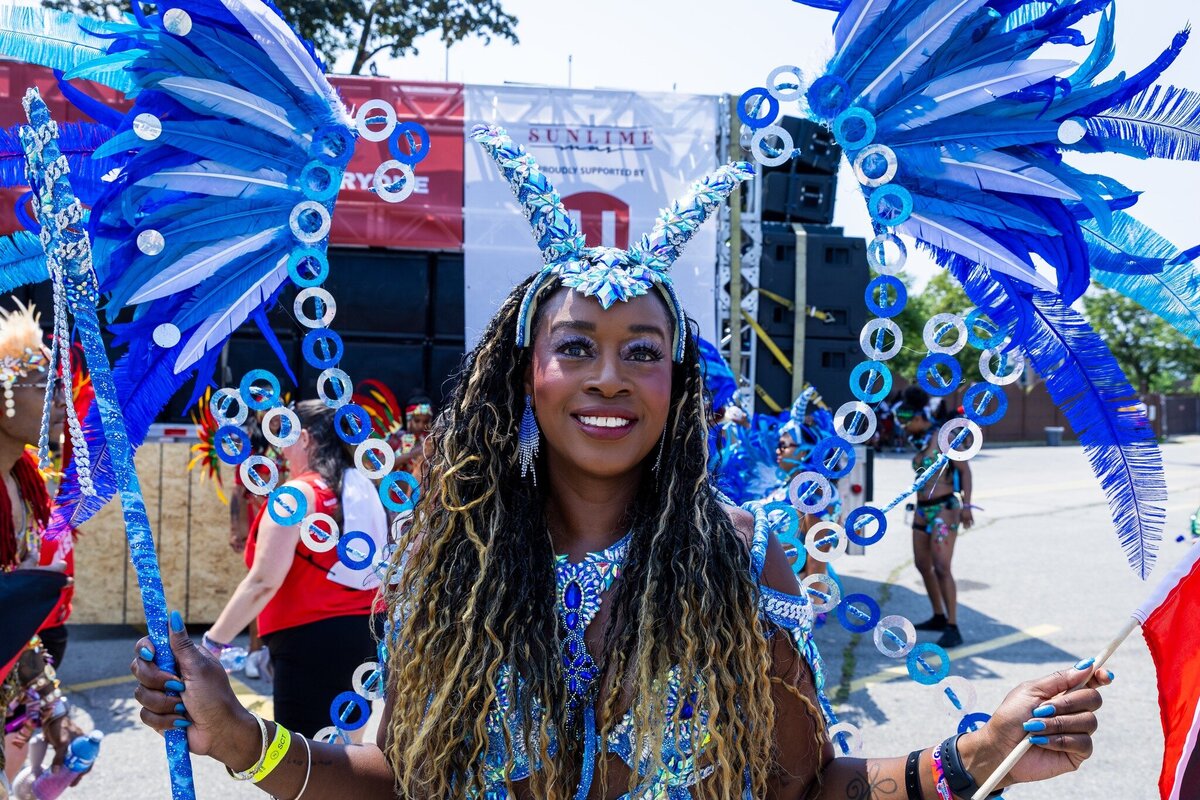 Toronto caribbean carnival parade masqueraders having fun in costume with Sunlime Mas, the number 1 medium size band at Toronto Carnival.