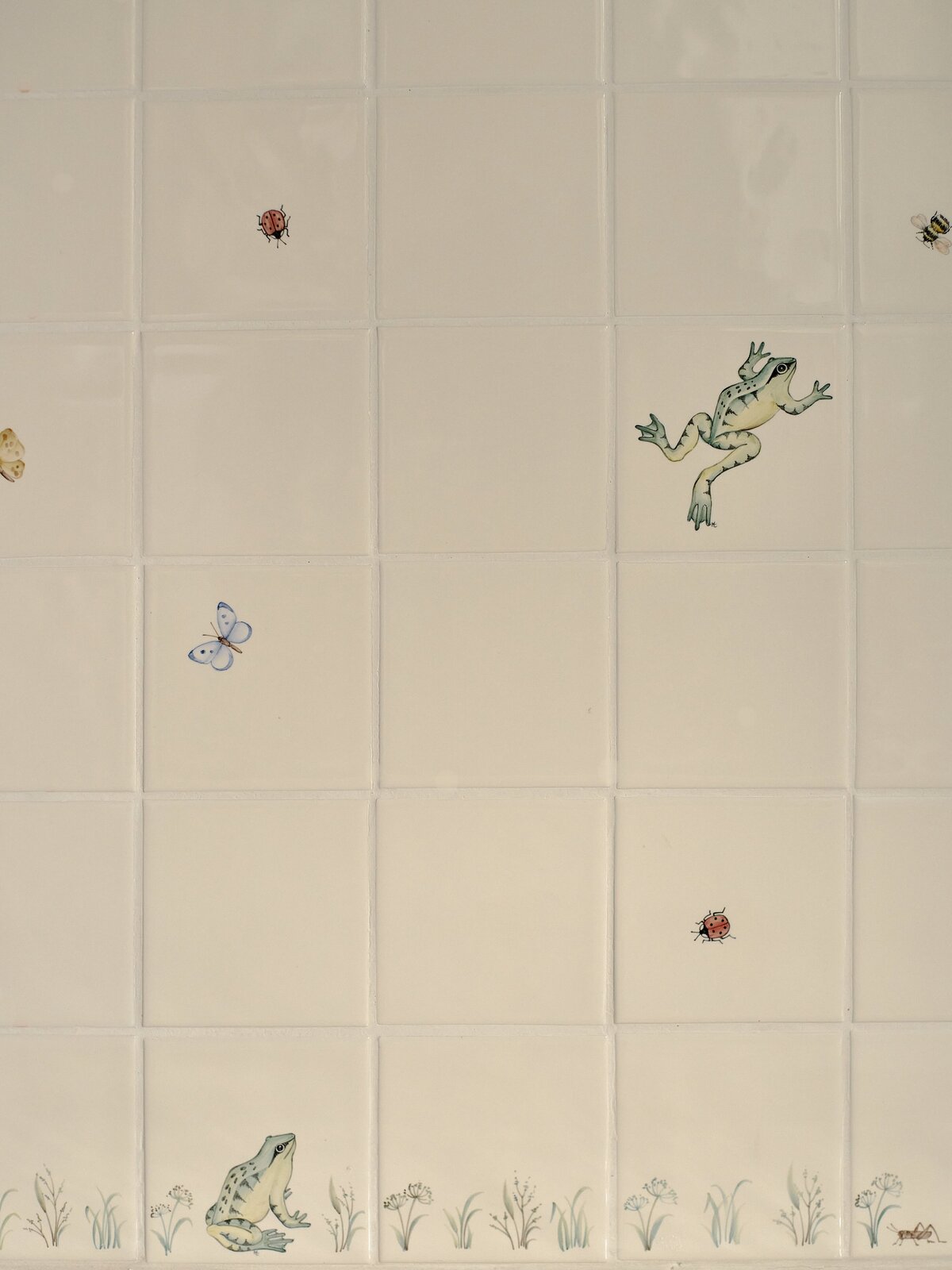 hand painted tiles with frogs jumping