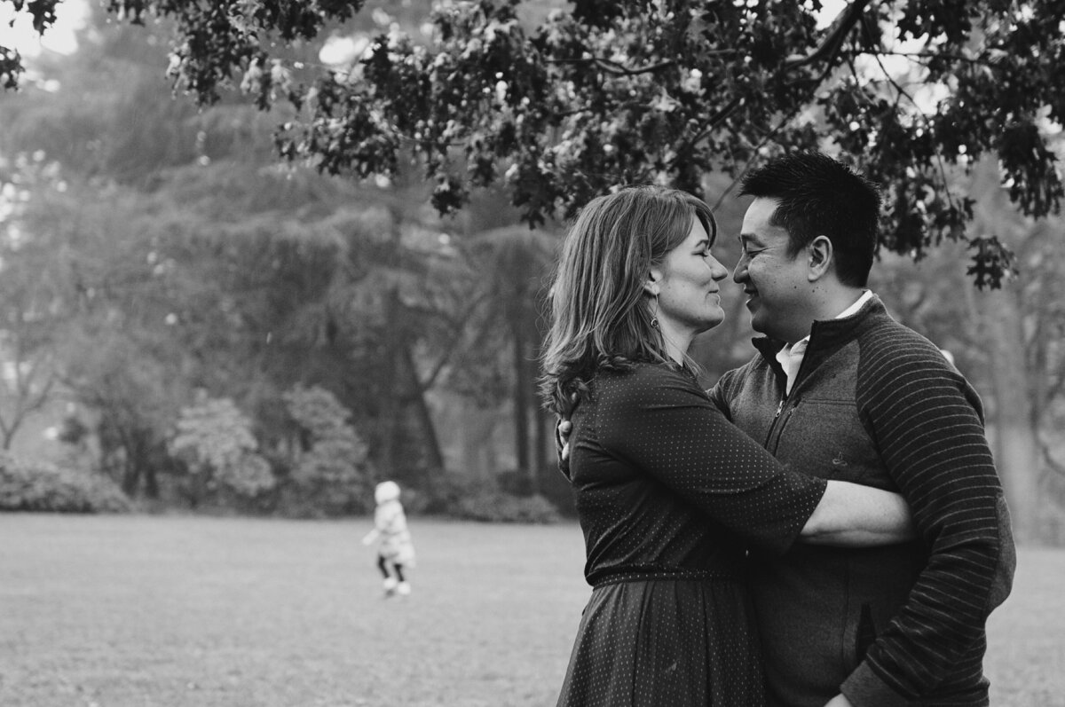 A couple with their arms around each other about to kiss