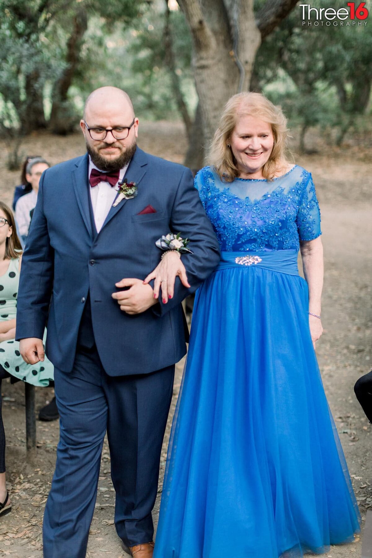 Groom walks his future mother in law up the aisle