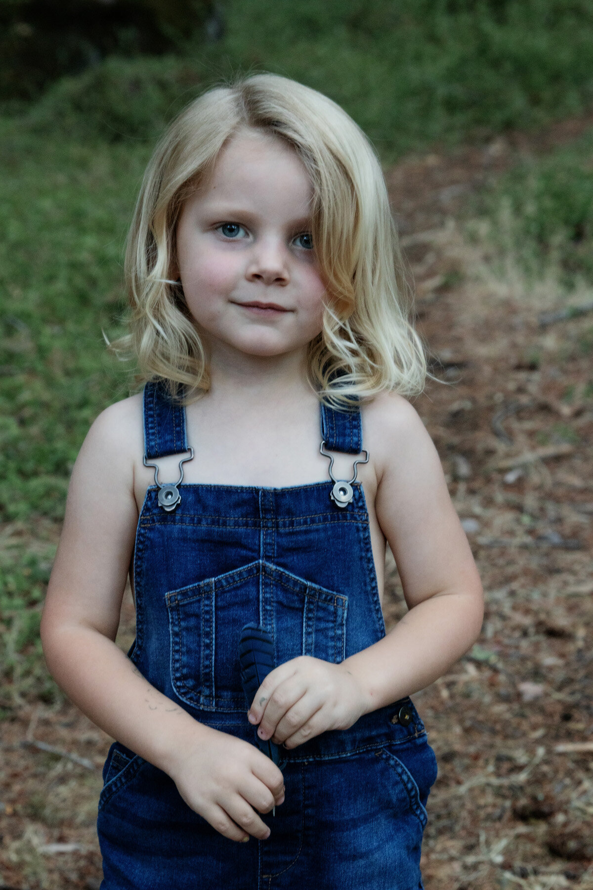 little boy in overalls