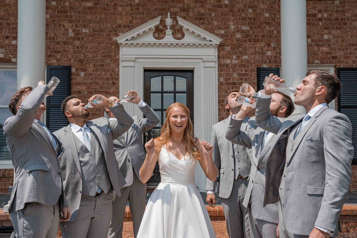 a bride icing the groomsmen before the ceremony