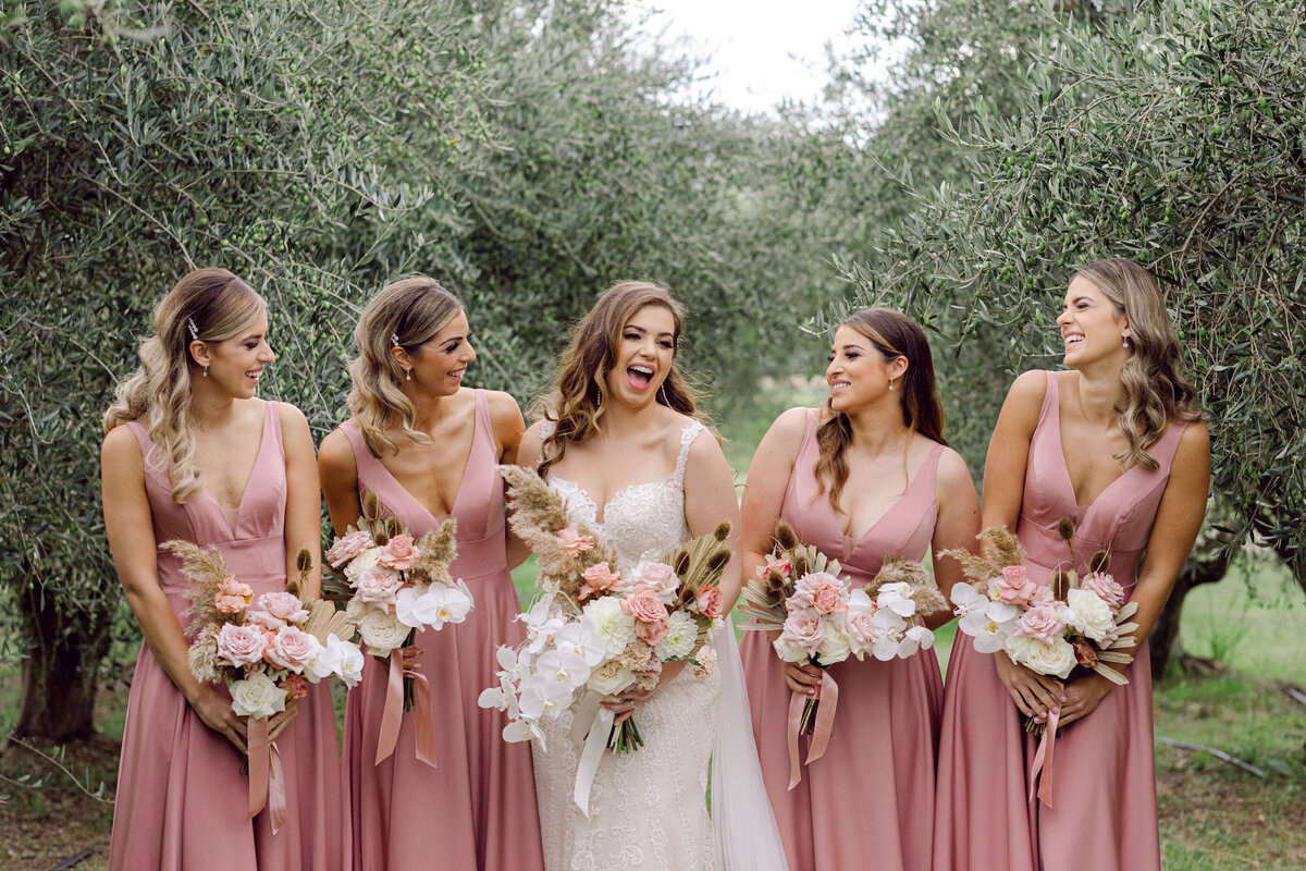 Bride and Bridesmaids in Blush pink gown with wedding bouquet