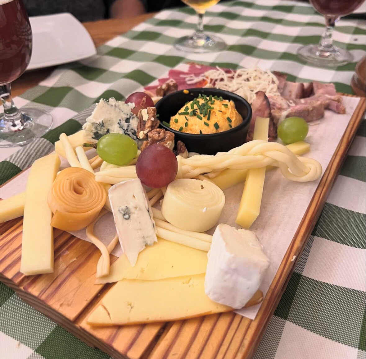 Cheese, fruit, and meat platter on a wooden platter