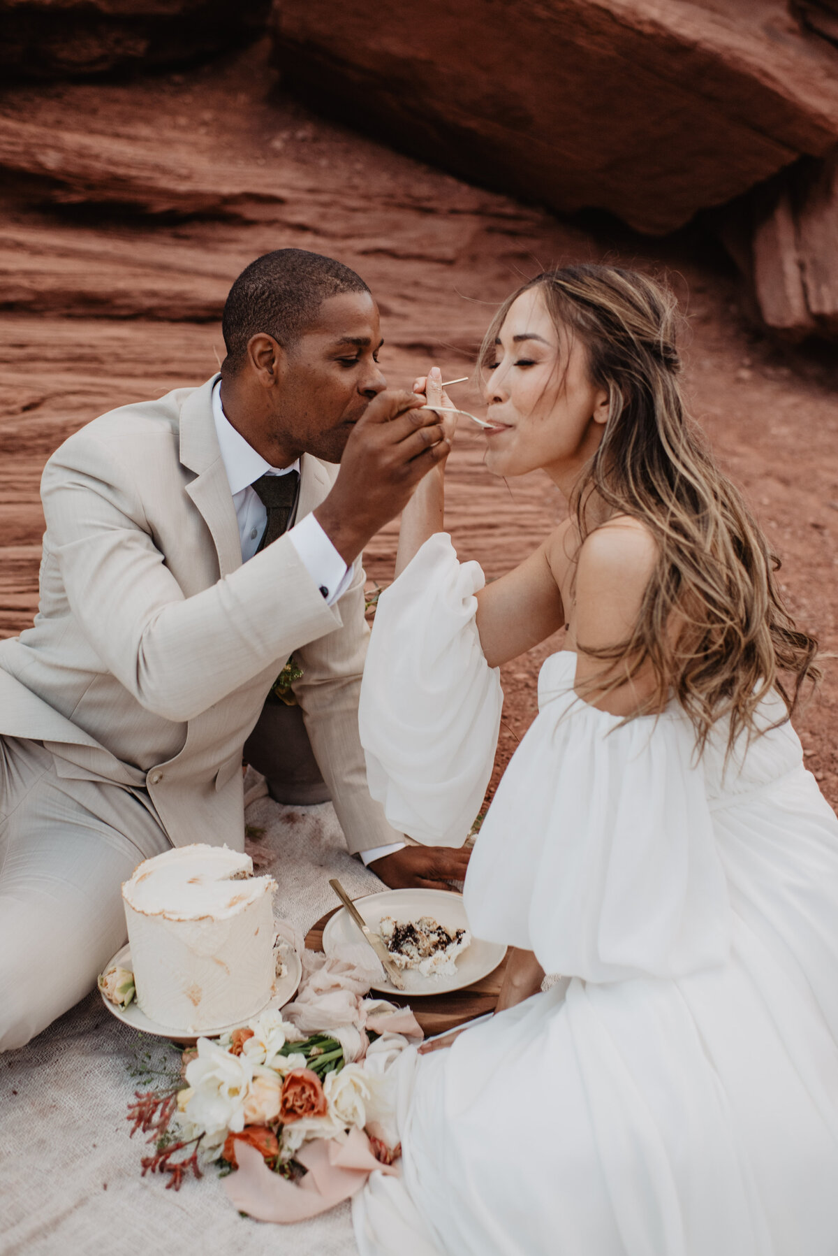 Utah Elopement Photographer captures groom feeding bride cake