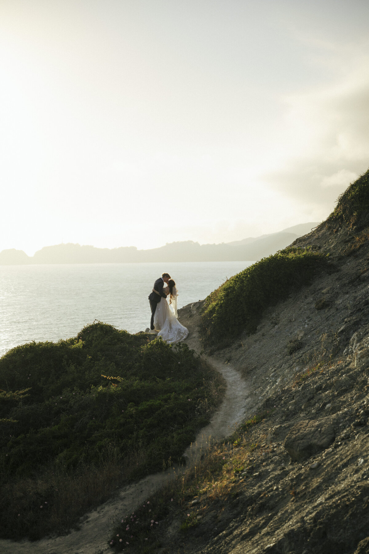 Bride and Groom at Marshall's Beach in San Francisco, California at sunset
