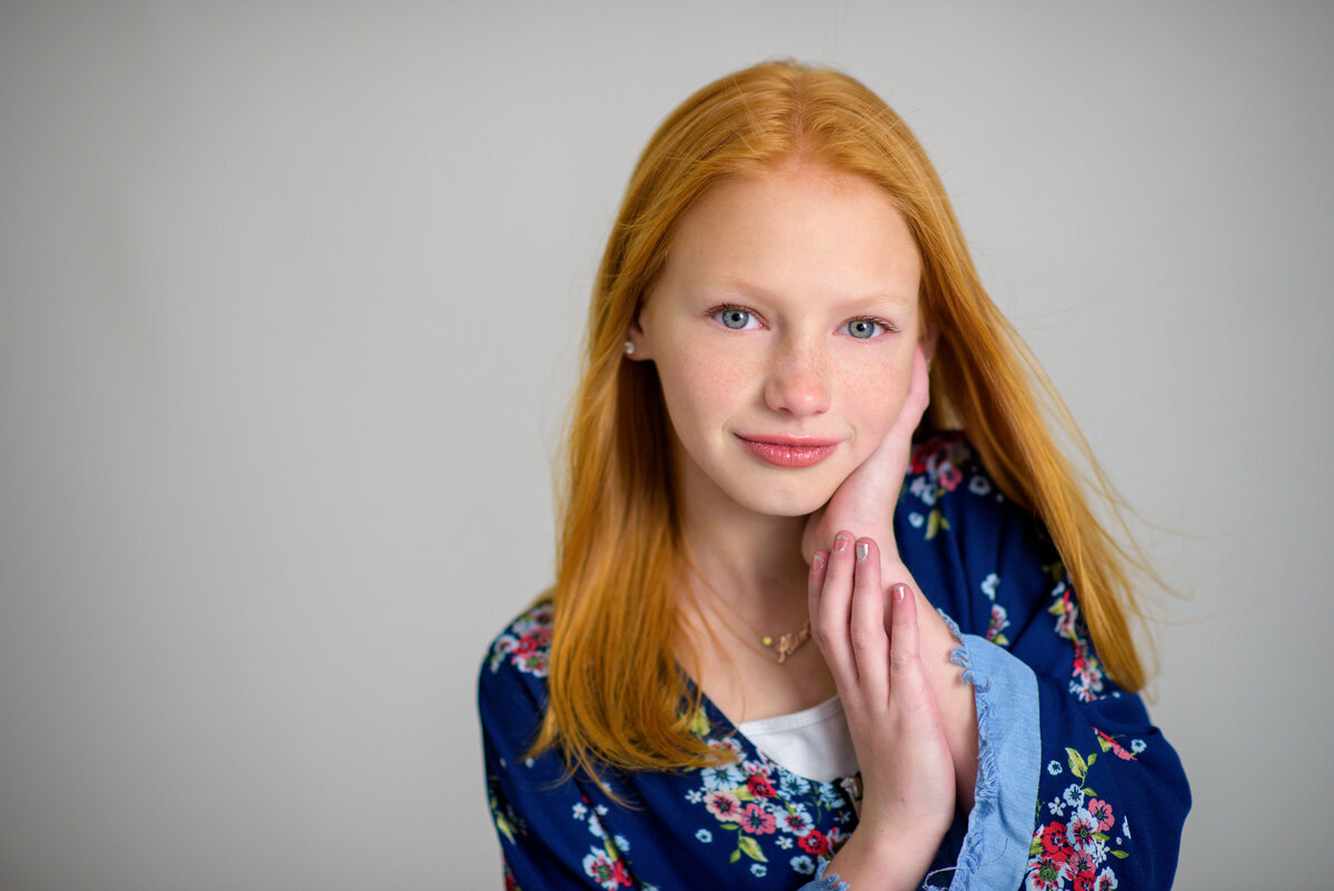 Tween girl with soft expression in photo studio in Boise.