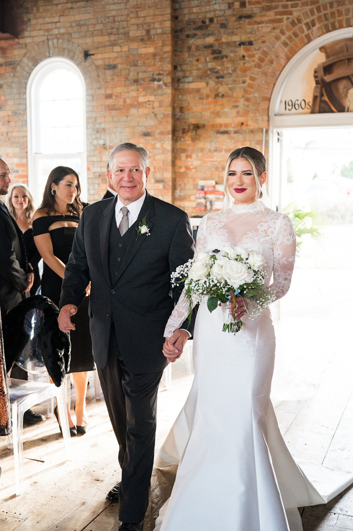 bride coming down the aisle with her dad on the wedding day