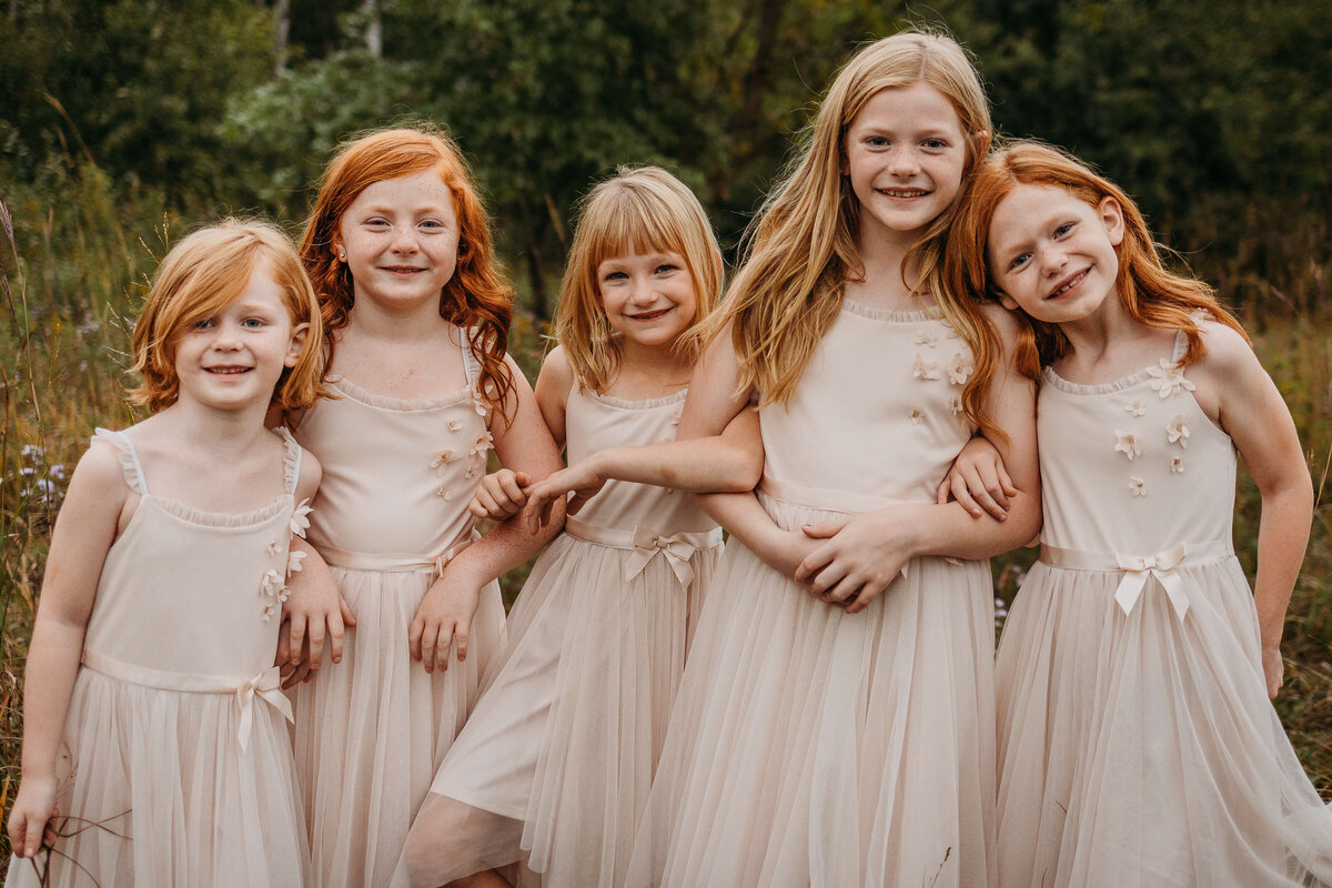Sisters in matching peach dresses for an Eau Claire family photography session