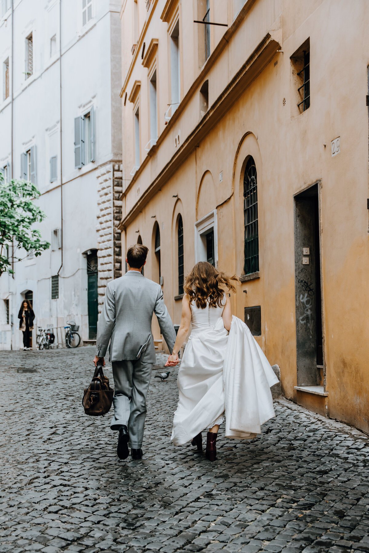 Intimate moment in a narrow Rome alleyway.