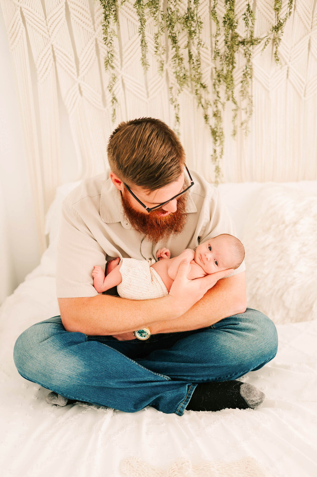 dad cuddling baby boy captured by Springfield Mo newborn photographer Jessica Kennedy of The XO Photography