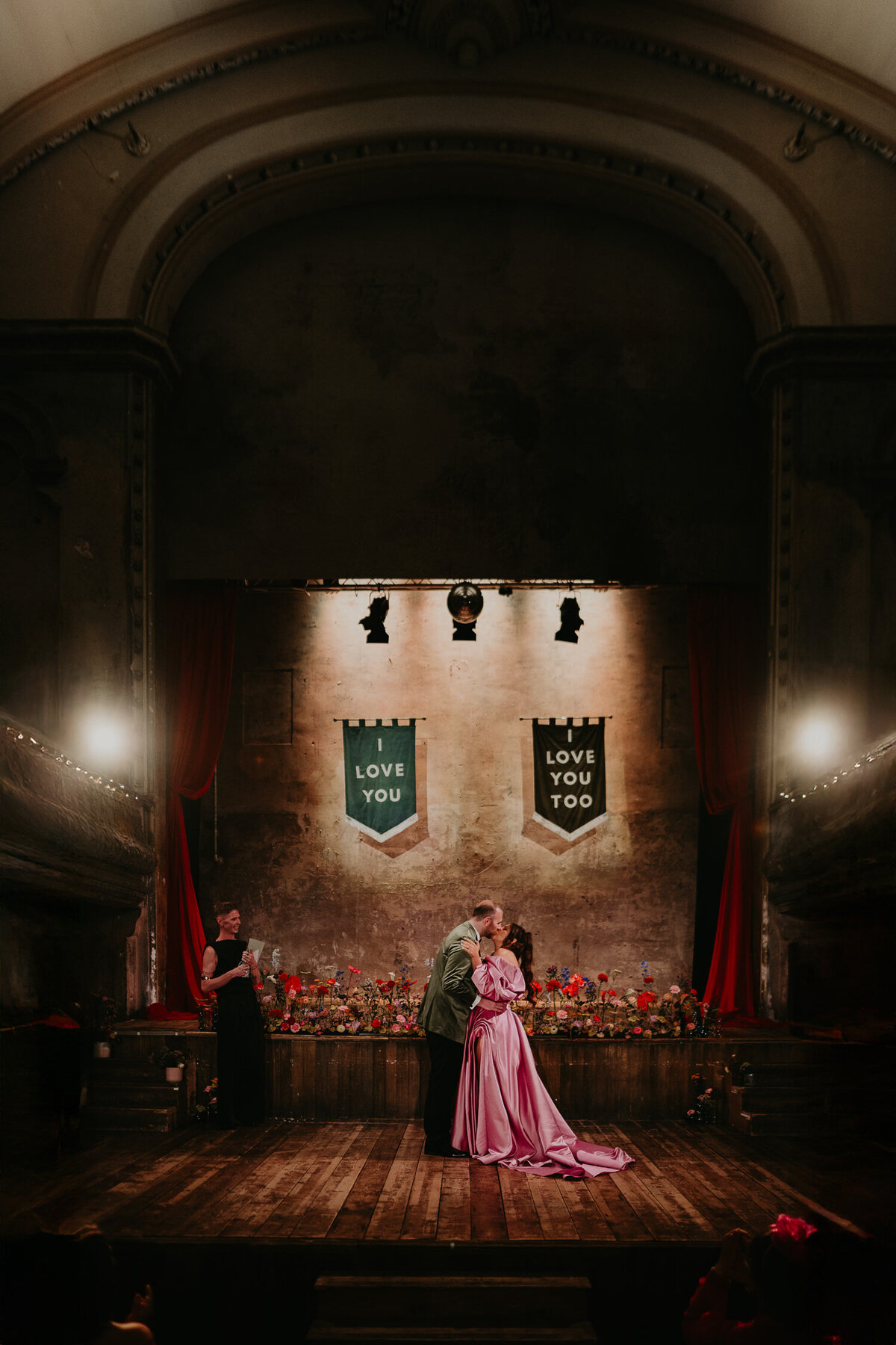 Bride and groom share their first kiss at Wilton's Music Hall. 