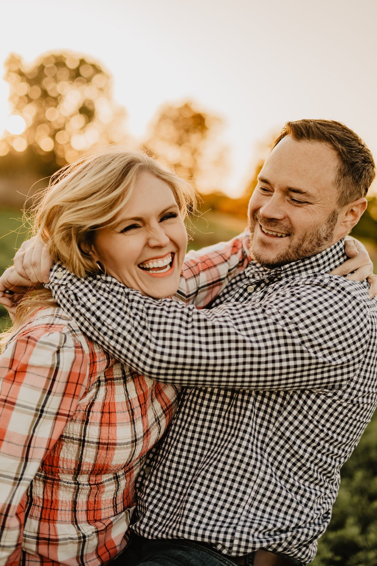 storyteller-collective-photo-co-couple-laughing-together-at-sunset-iowa