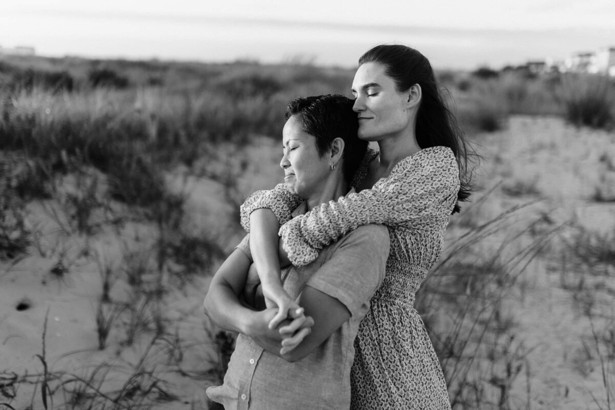 Lesbian couple holding each other on the beach - Ocean City NJ