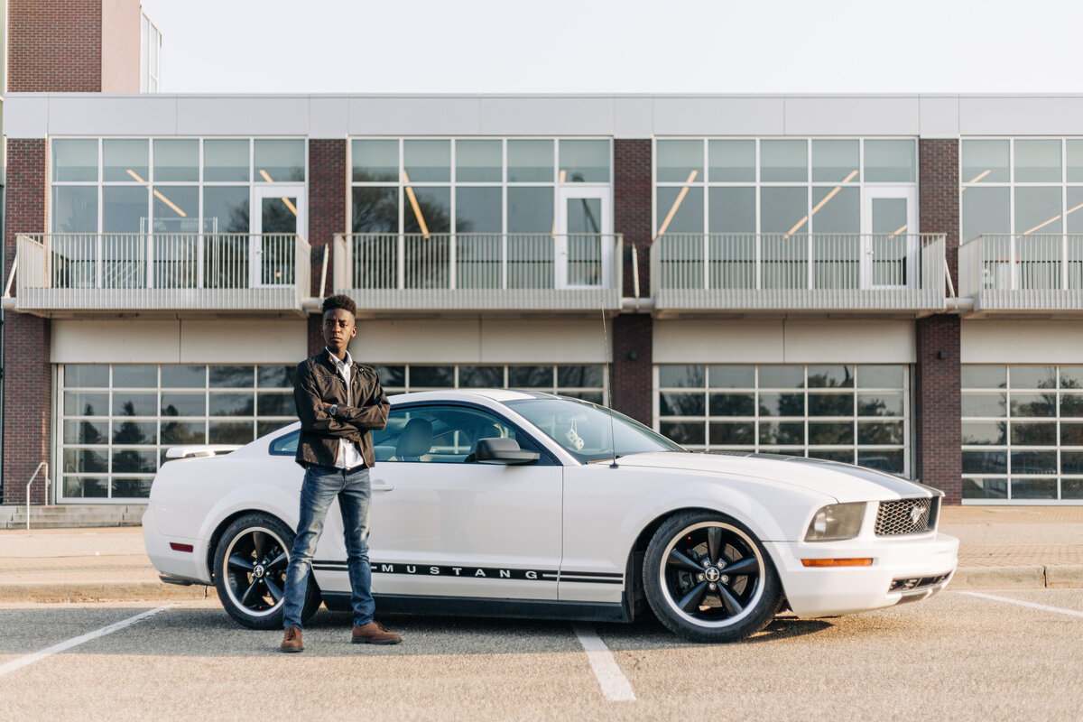 guy standing by mustang with arms crossed