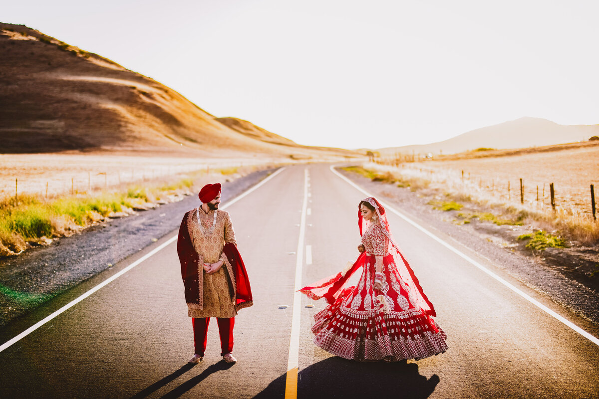 Sikh bride twirling in the middle of the road in yuba city california after the anand karaj wedding