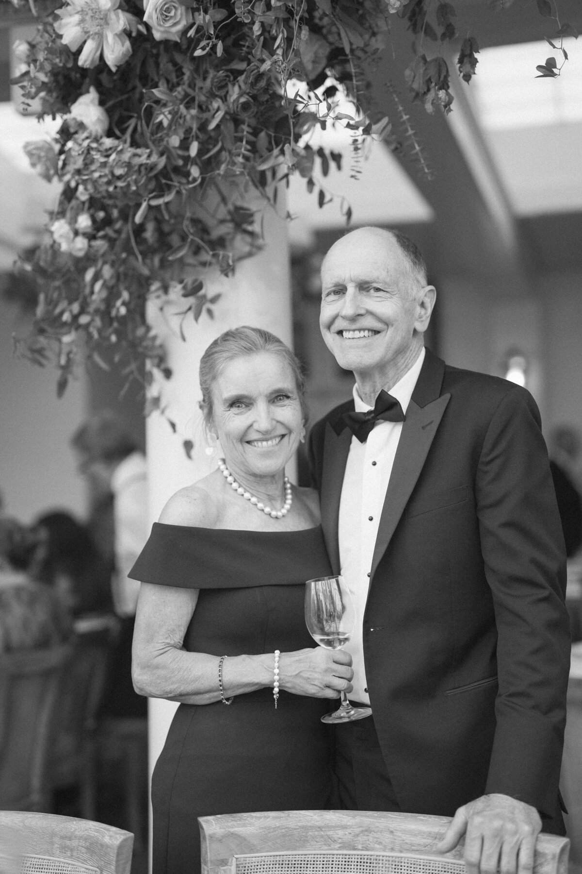 An elderly couple smiling in a heartfelt moment at the wedding.
