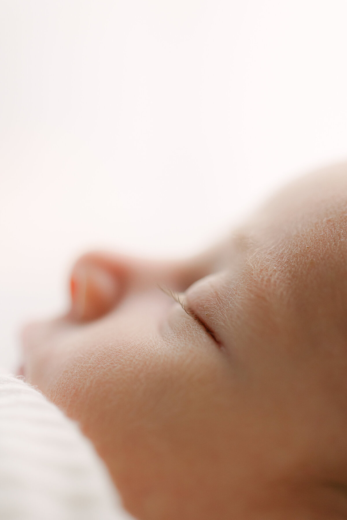 Macro image of a newborn's eyelashes and baby hair by Indianapolis photographer, Brittney Lear