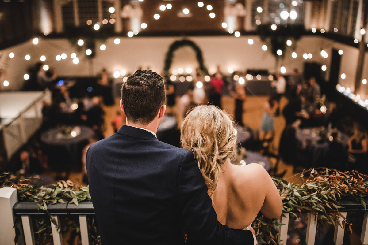 Newly Married couple at the second floor looking at their guests on the ground floor