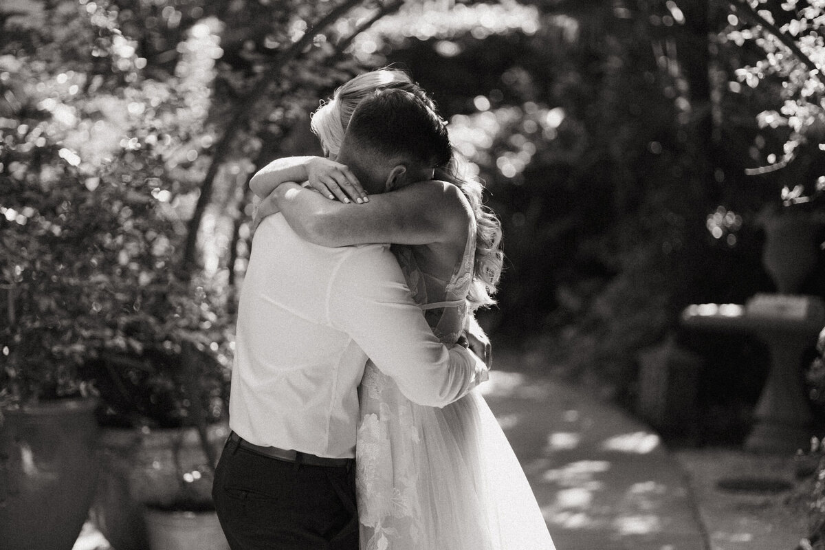 A bride and groom embrace during their candid first look before their wedding ceremony.