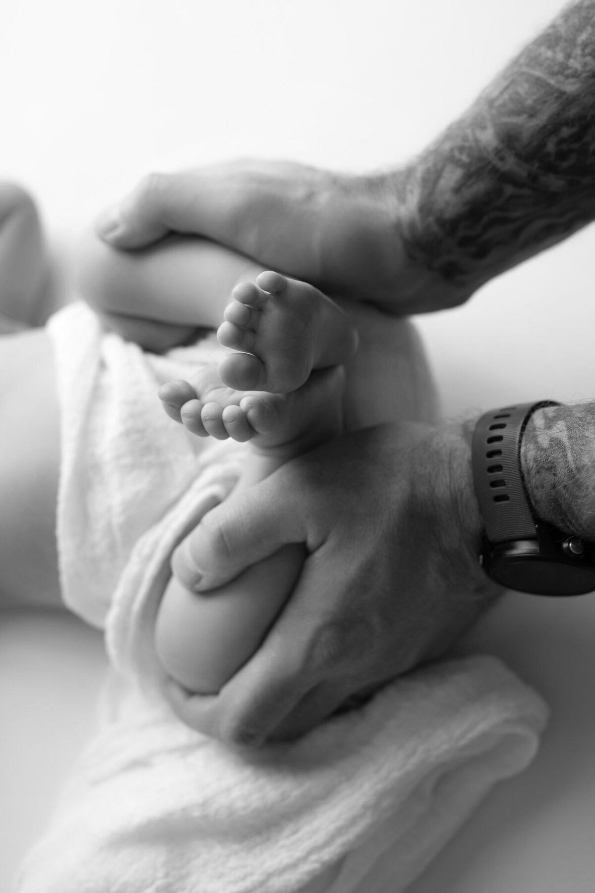 Father holding newborn baby black white portrait Georgetown family photographer