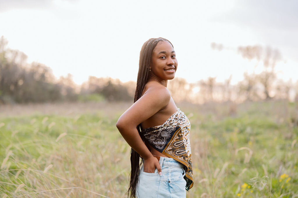 girl poses for senior portraits in kansas city