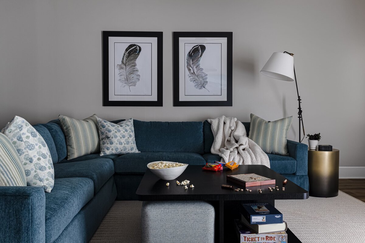 melinda chesson interiors meadowood place cozy living room with blue sofa and black framed artwork on wall