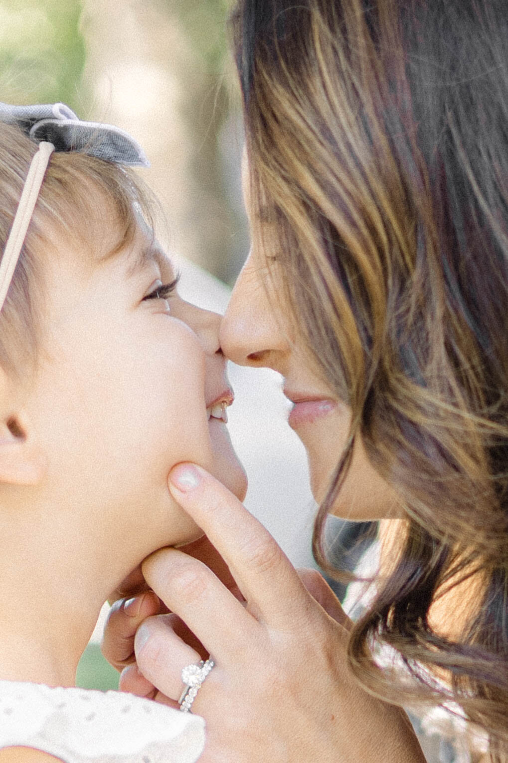 Close up of mom and daughter making nose kisses during their family photography session.