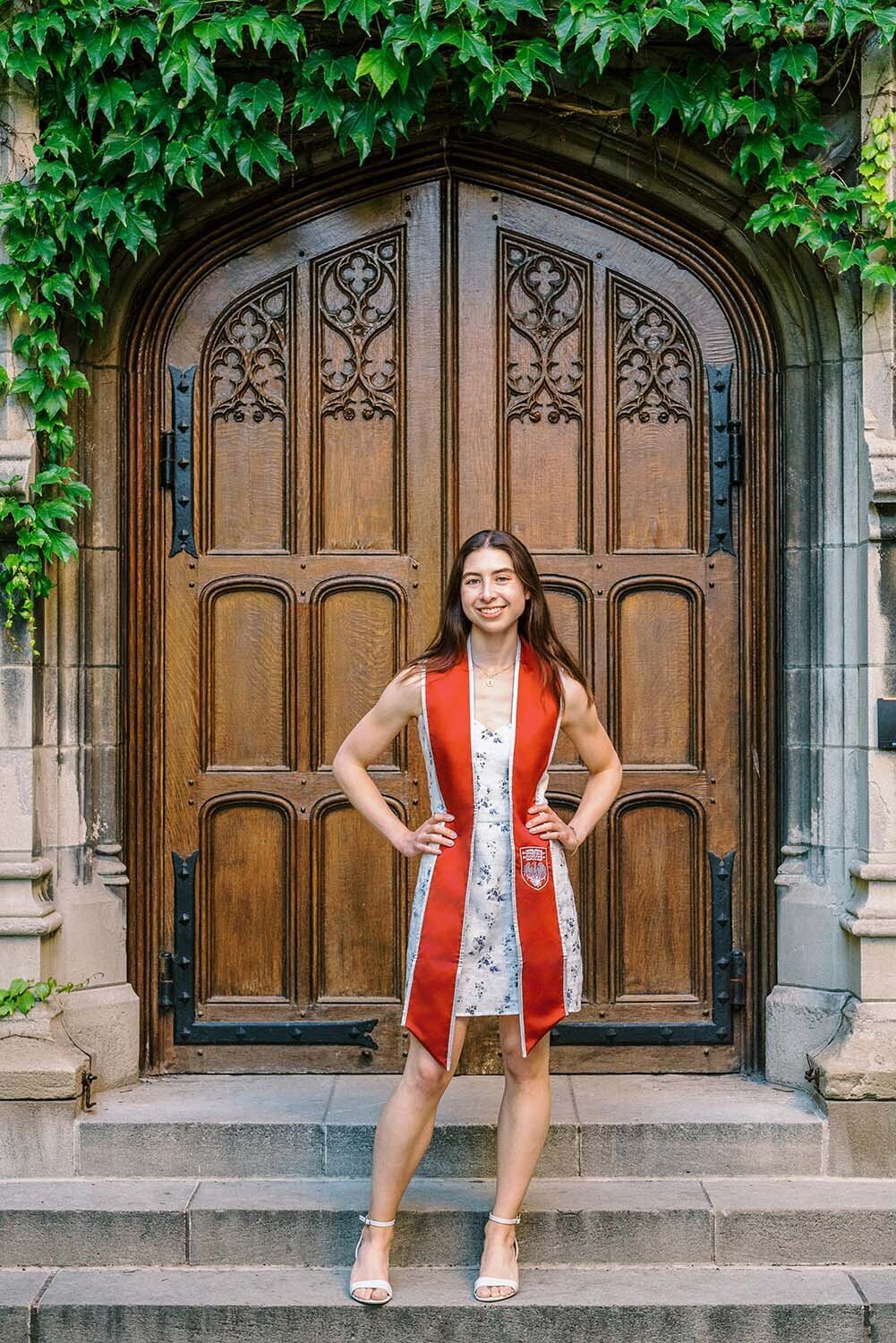 UChicago graduation photos in front of the door at Bond Chapel