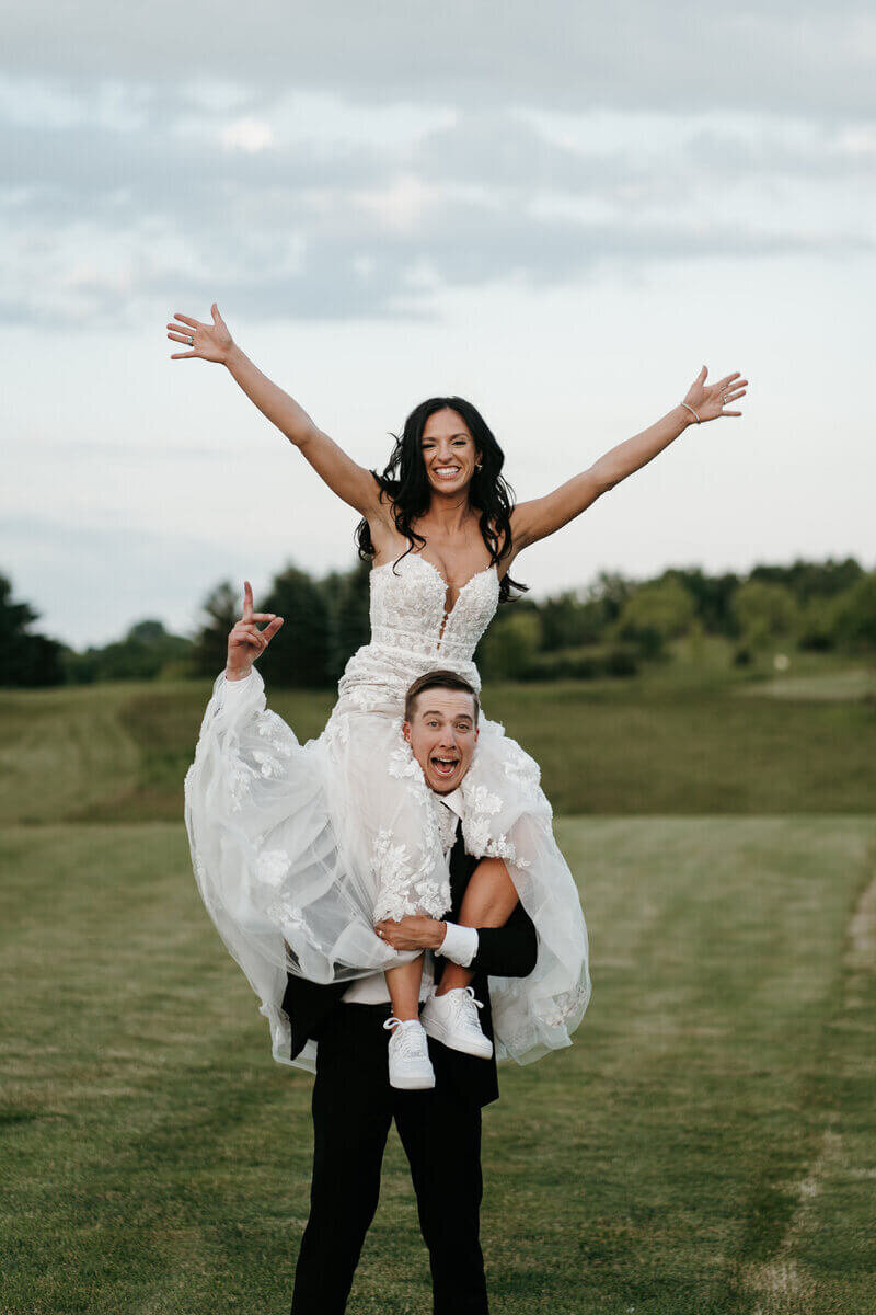 Groom holding bride up by luxury wedding planner chicago