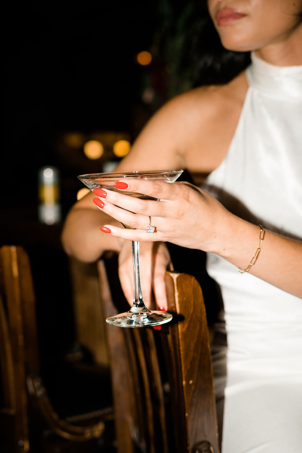 close up view of a martini glass held by a bride