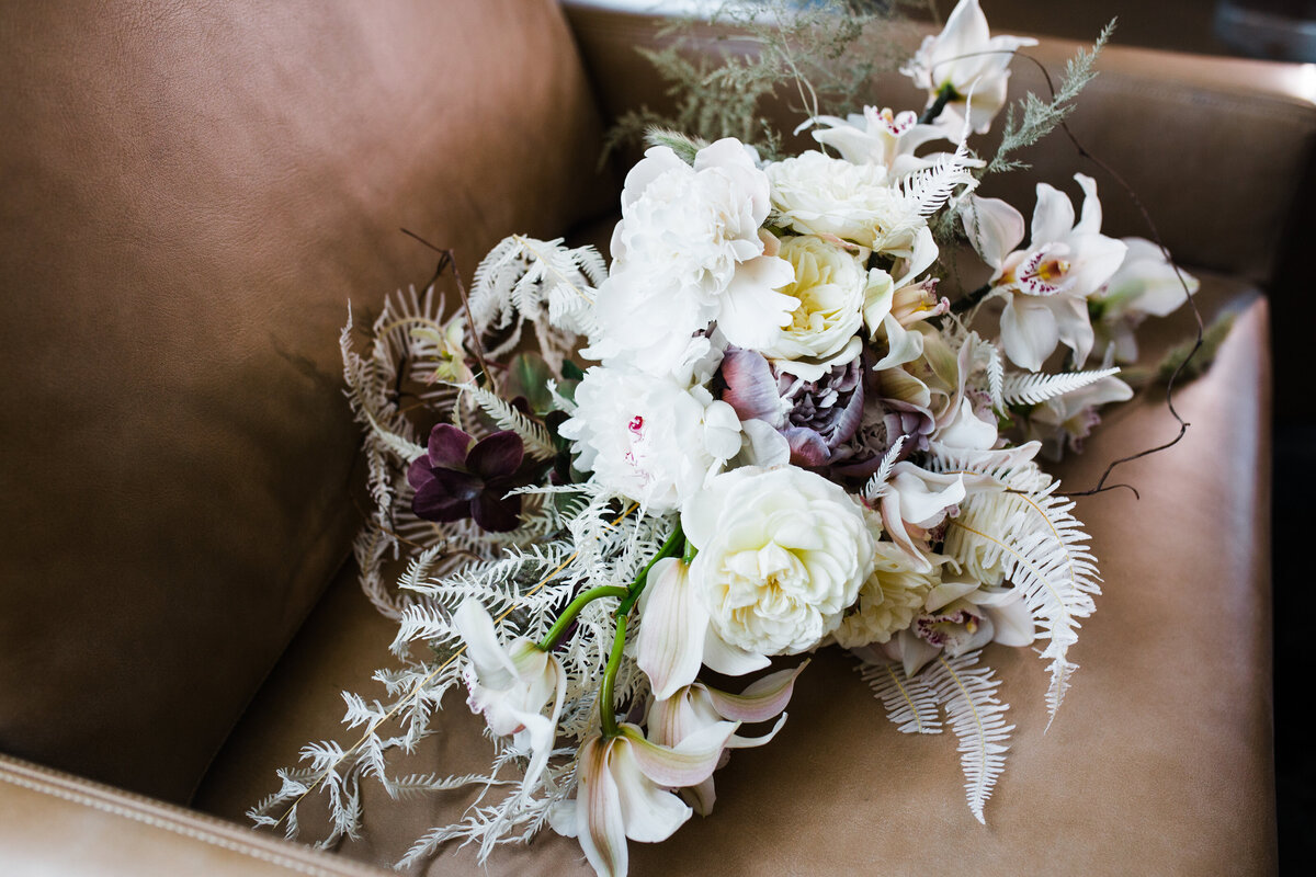 drides bouquet sitting in leather chair