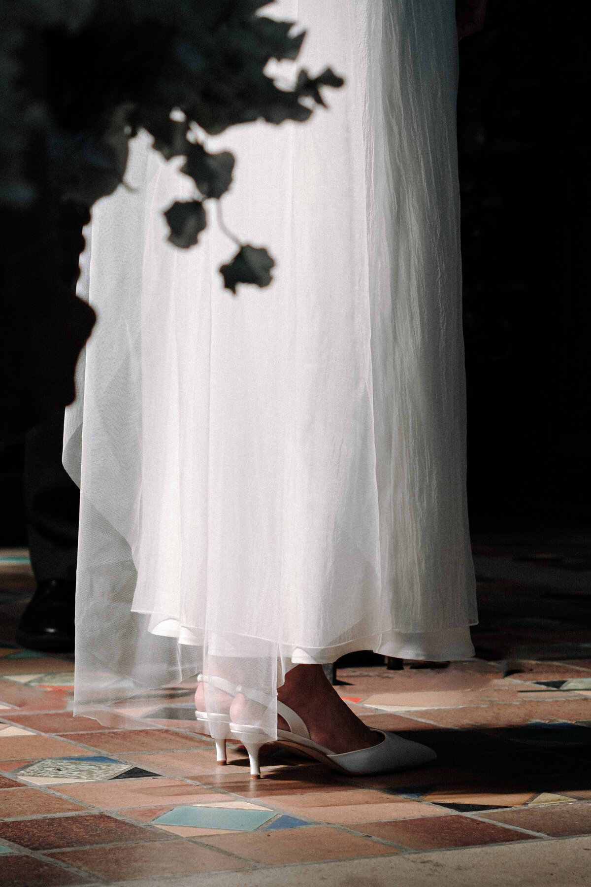 sun lighting up bride's shoes at ceremony
