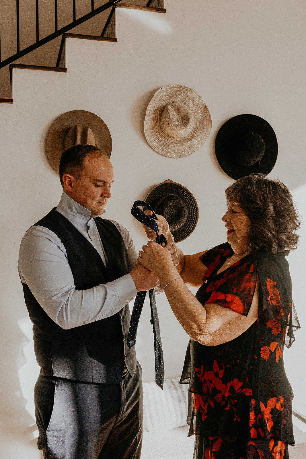 groom and his mom getting his tie put on