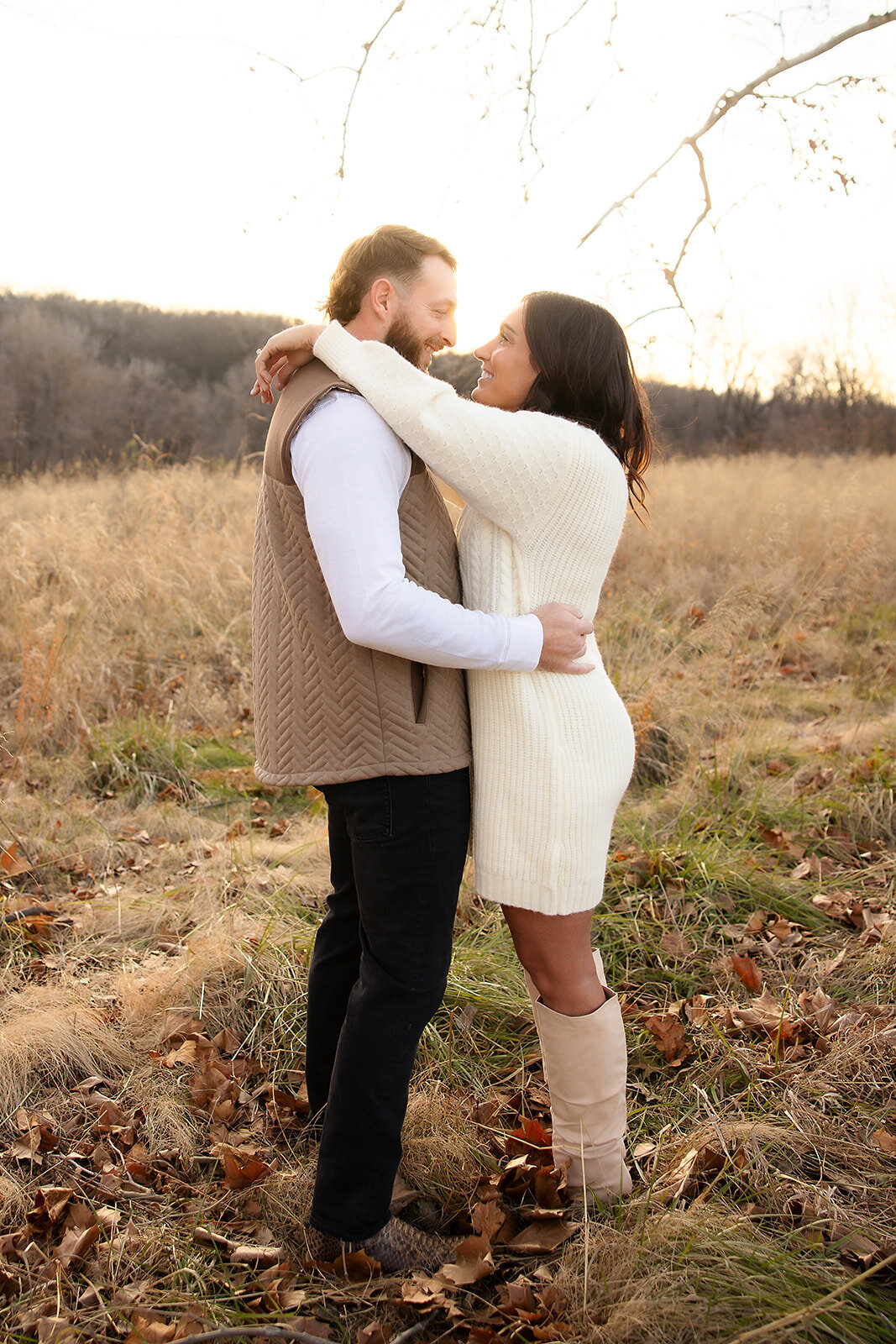 Engaged Couple hugging in field