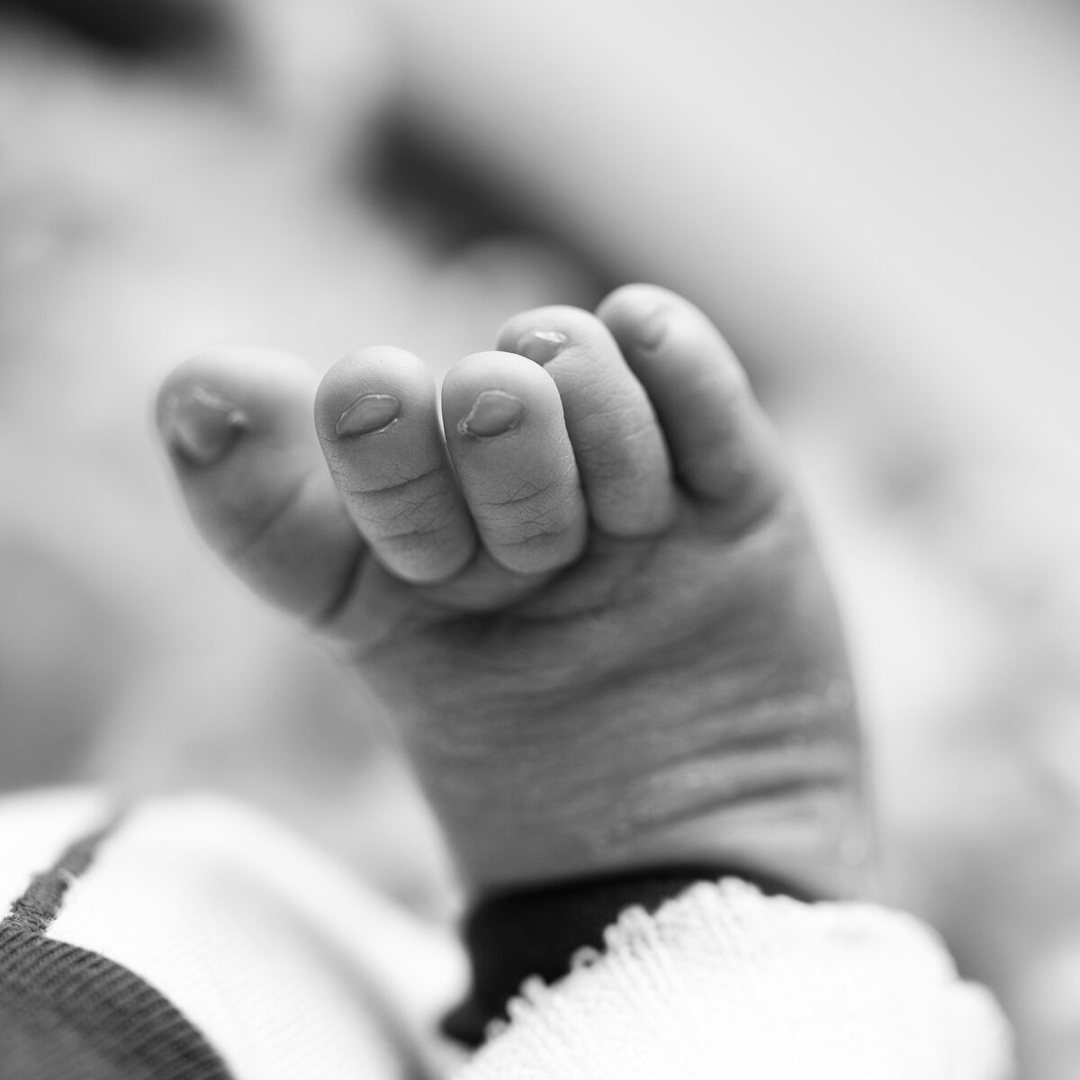 Sweet, wrinkled toes tell the story of a beautiful beginning in this fine-art macro capture.