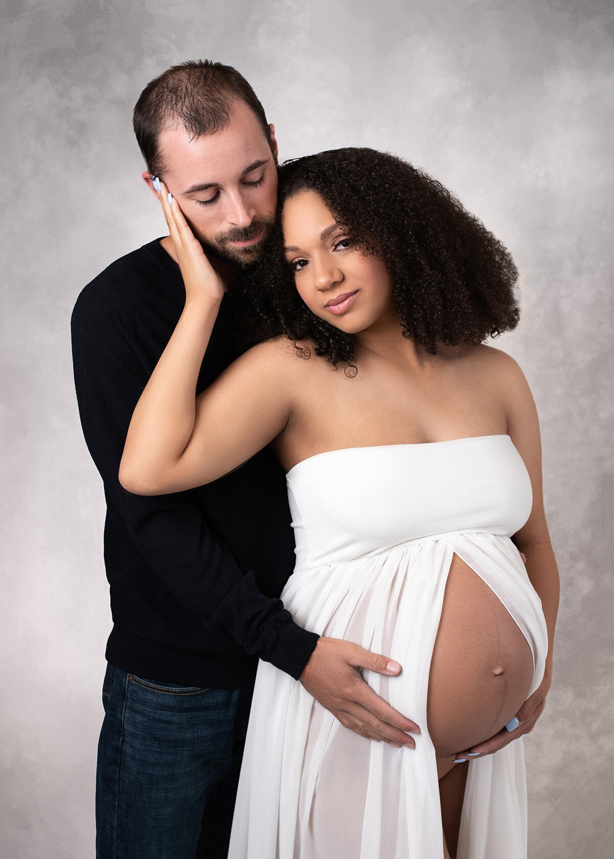 Maternity portrait of a stunning biracial couple.