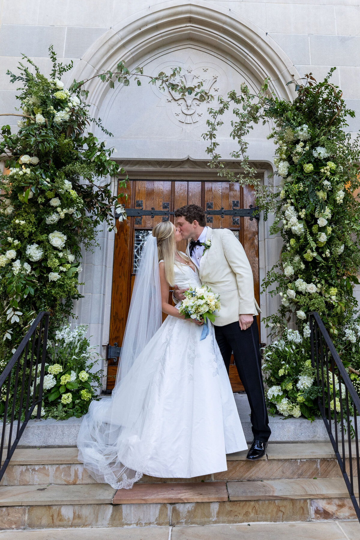 Bride and Groom Kiss outside Christ the King Atlanta
