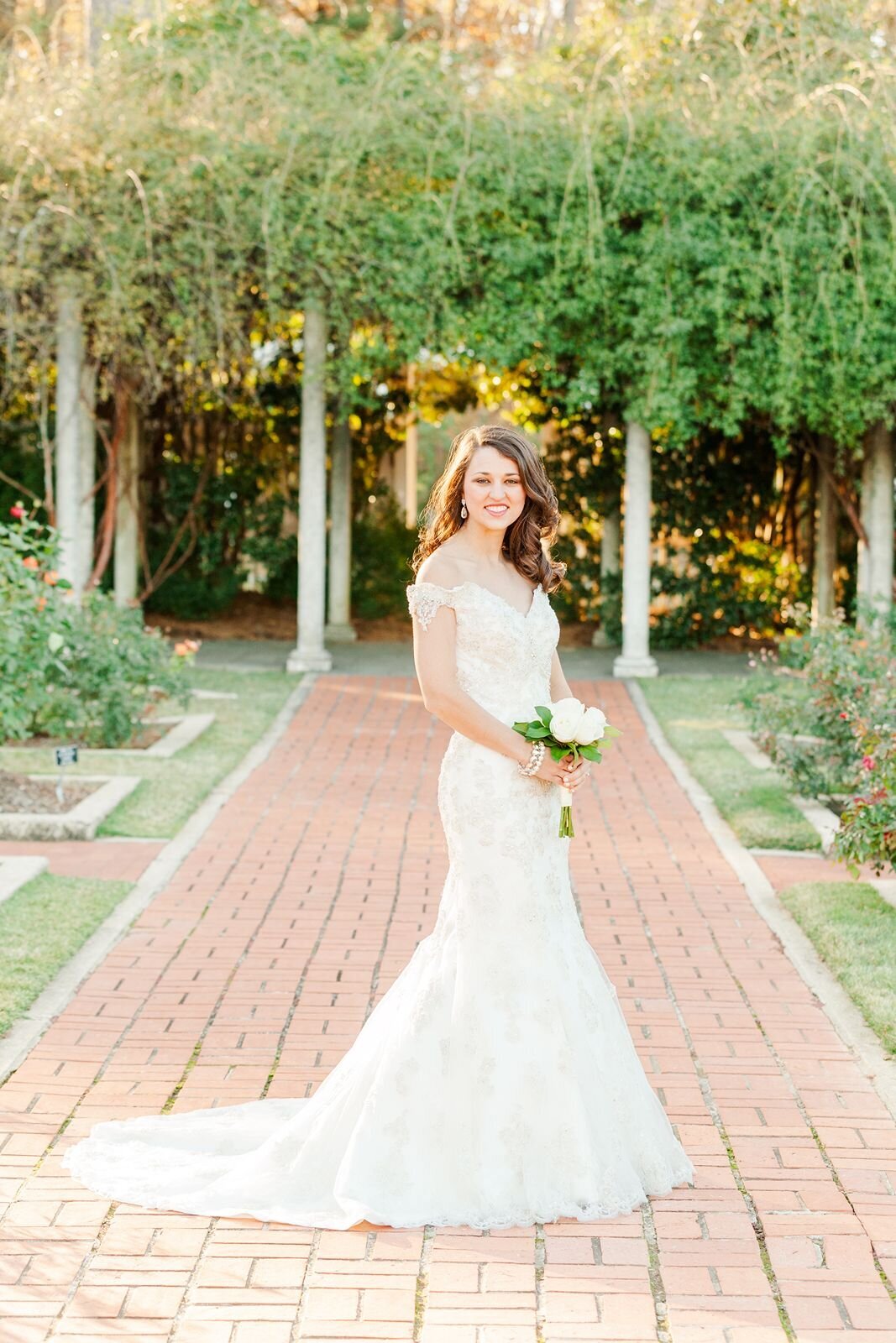 Elegant bride poses for portrait in golden hour light