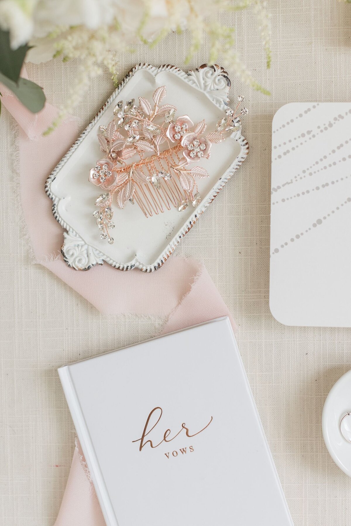 Flatlay with vows and haircomb