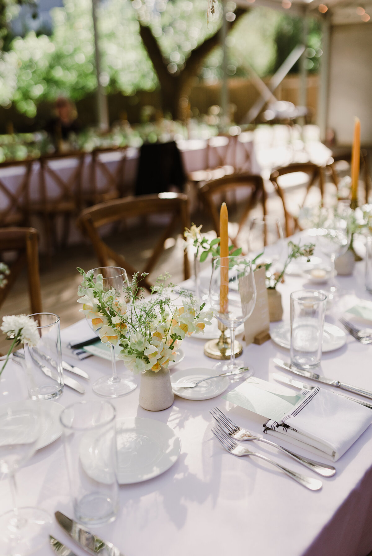 Wedding tablescape with white linens and white florals at Mattie's wedding venue in Austin