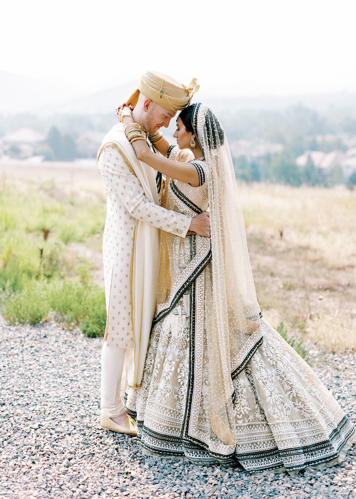 Bride and groom embracing at a South Asian Fusion wedding in Colorado