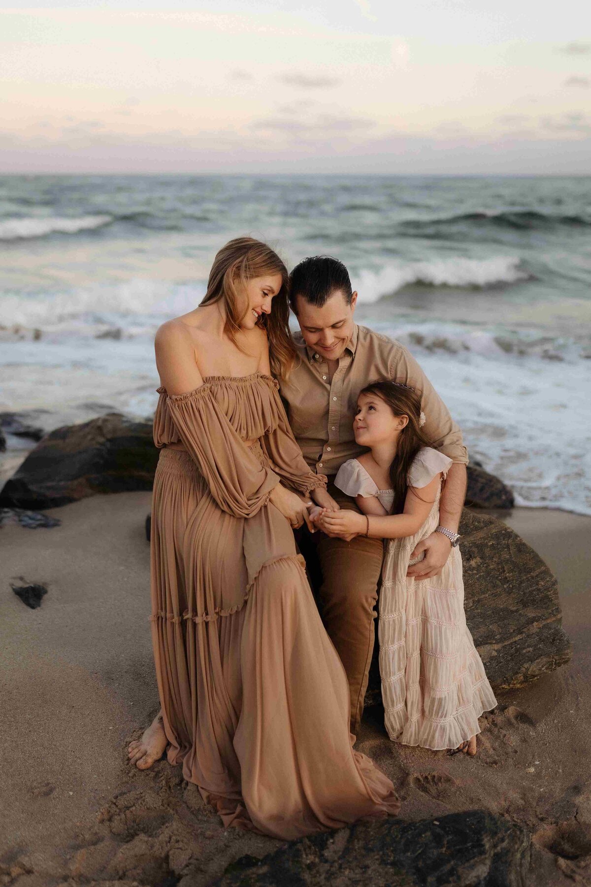 Miami family photographer: capturing a loving family at sunset on a beautiful beach, with ocean waves