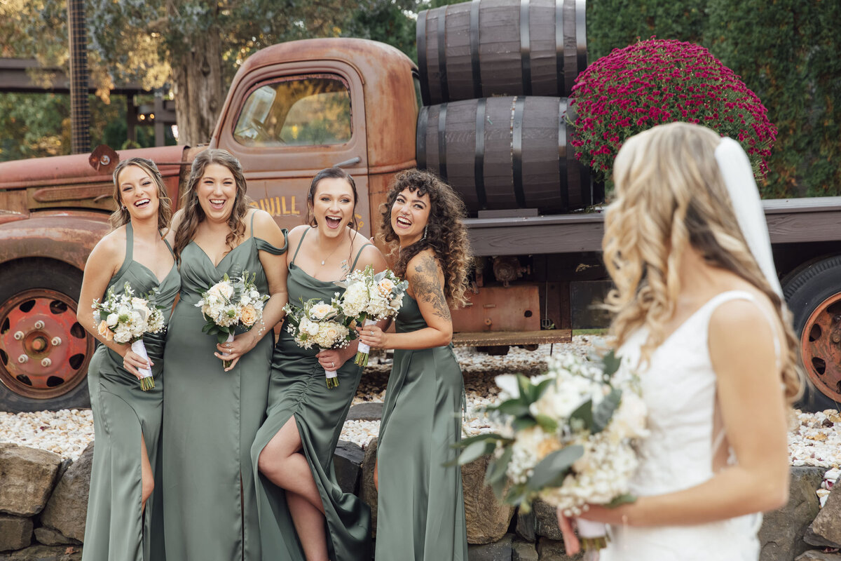 Hamilton Manor | Bride looking at bridesmaids near classic truck during summer wedding | Hamilton Township, New Jersey