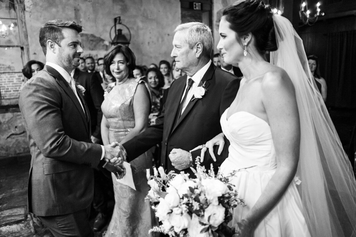 Bride's father shakes hand with groom