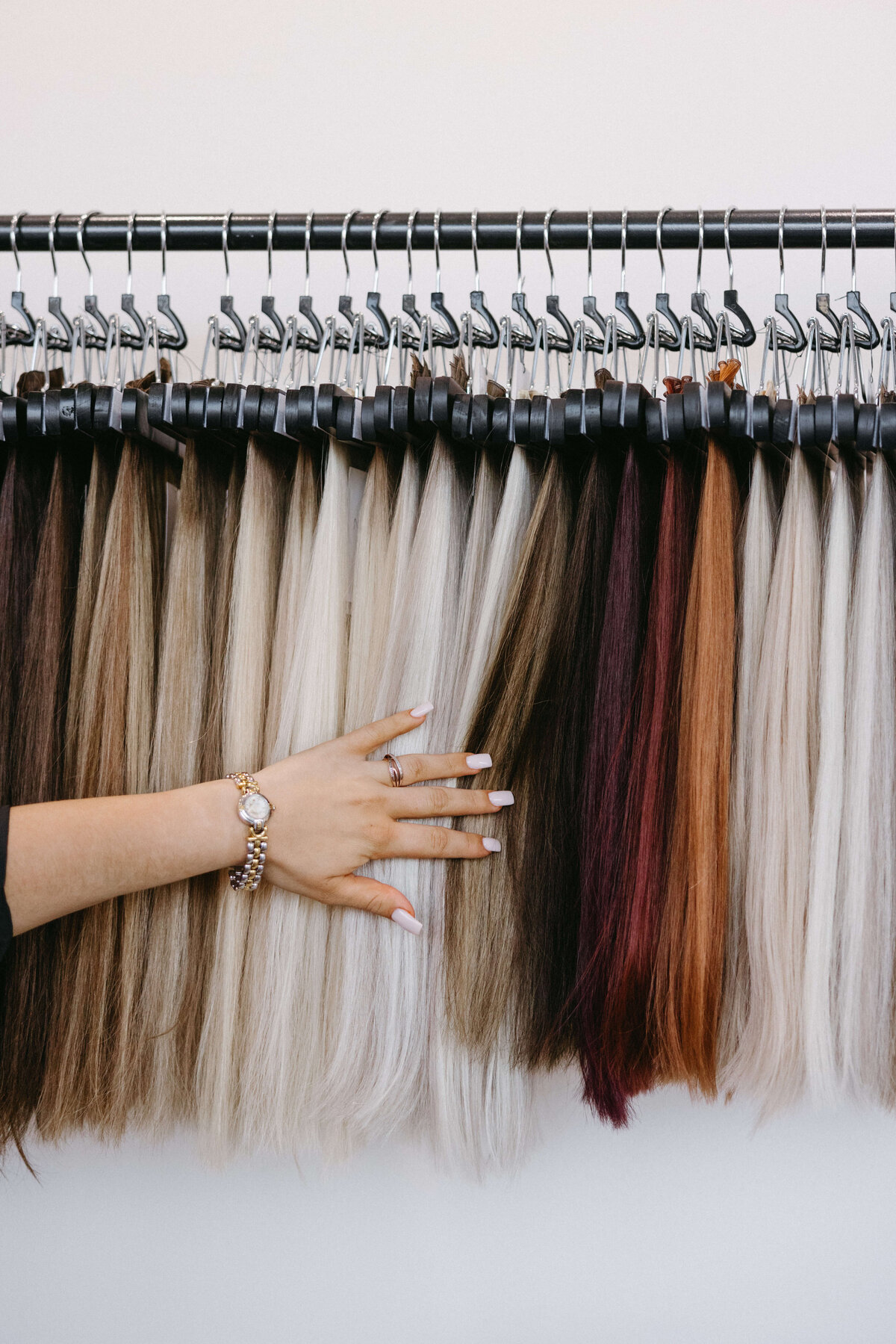 Rack of hair extension wefts at NOVA Strands