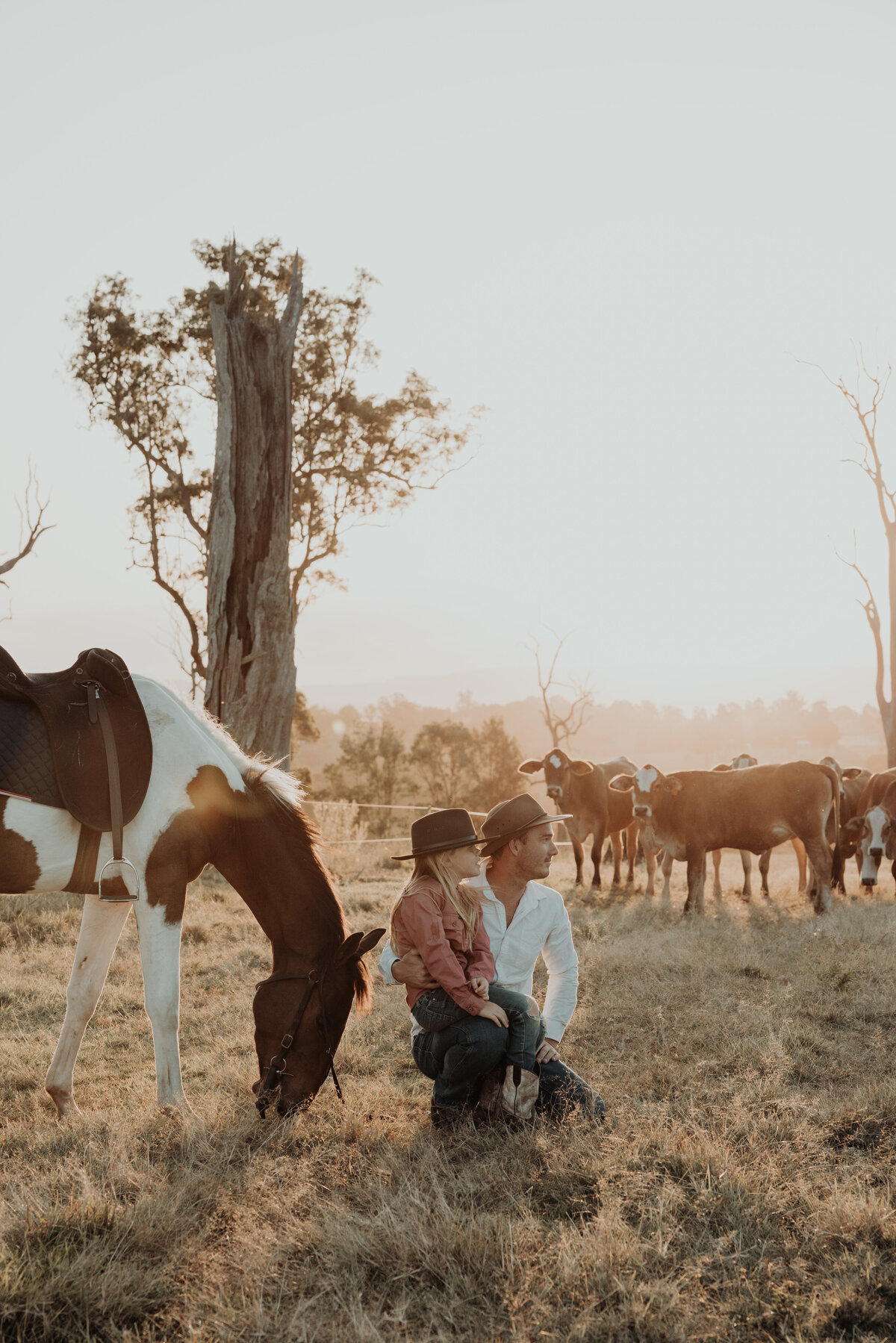 Father and daughter getting photos done on a farm