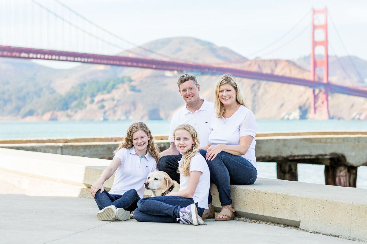 family with dog by golden gate