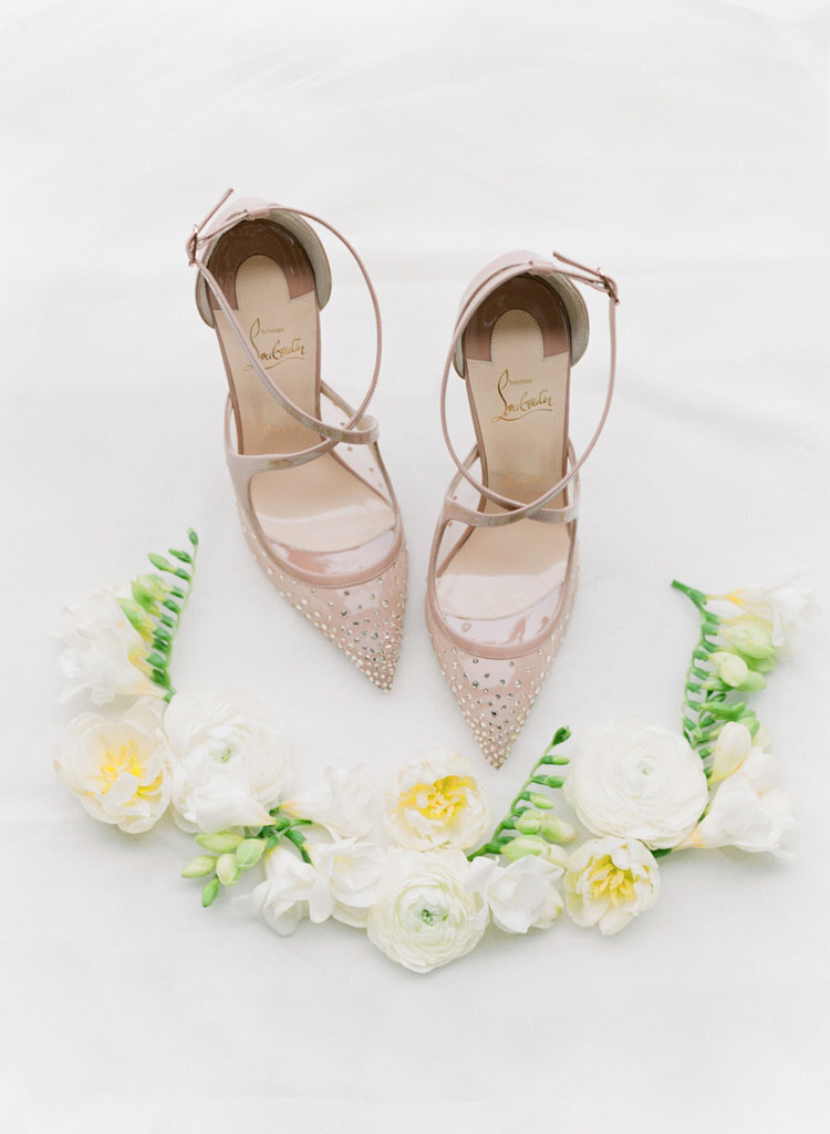 Bride's rose-gold shoes and floral piece
